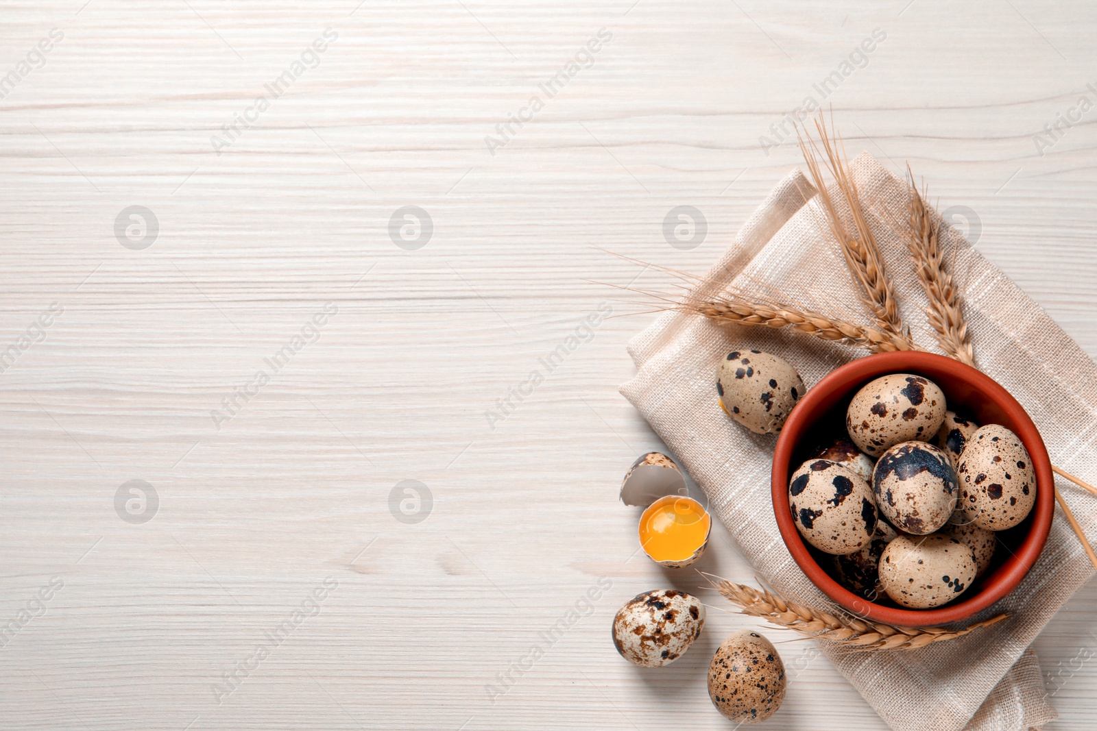 Photo of Flat lay composition with quail eggs on white wooden table. Space for text