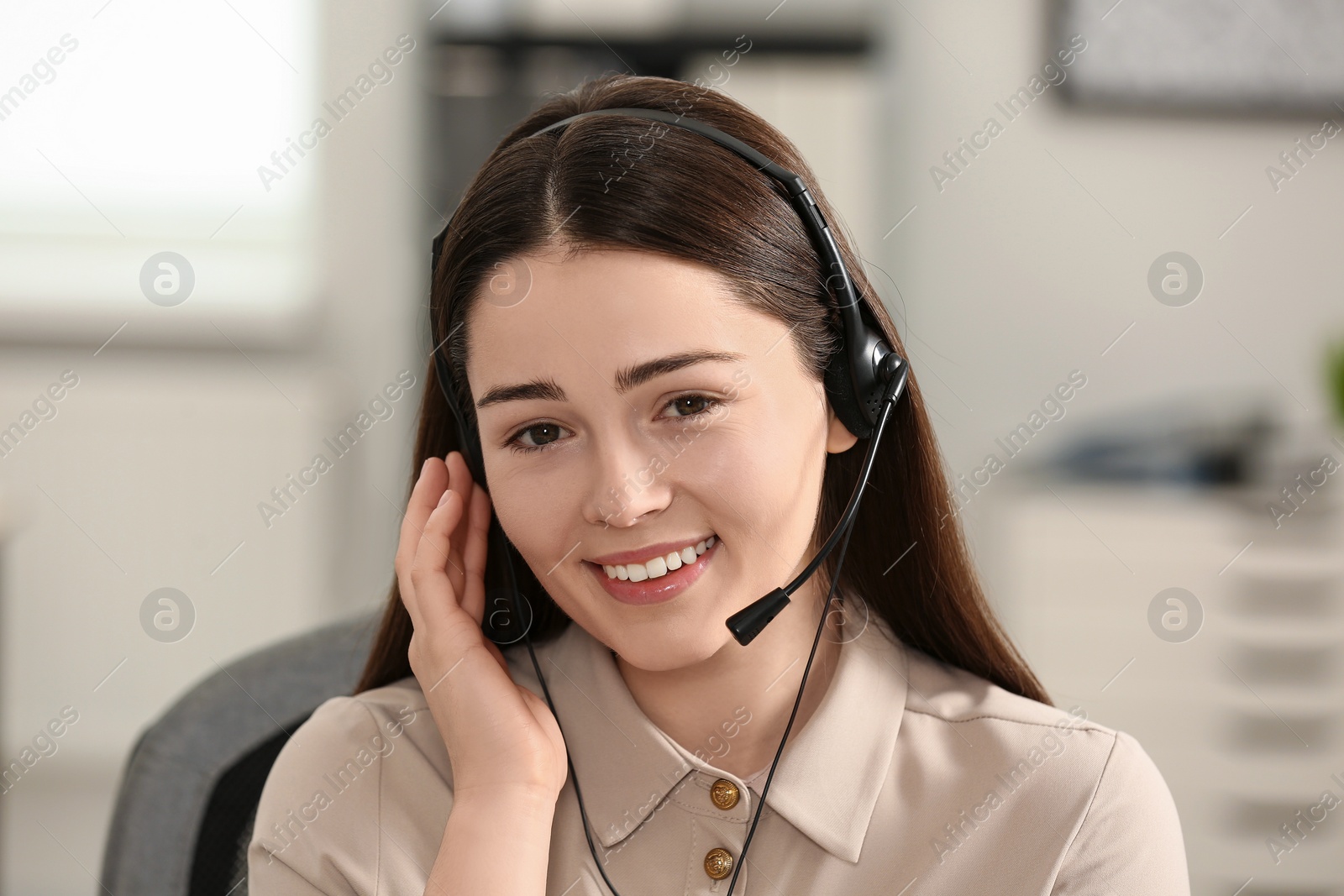 Photo of Hotline operator with headset working in office