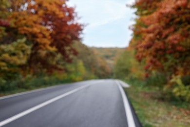 Photo of Blurred view of asphalt highway without transport near autumn forest