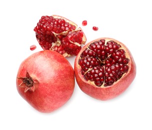 Photo of Whole and pieces of fresh pomegranates isolated on white, top view