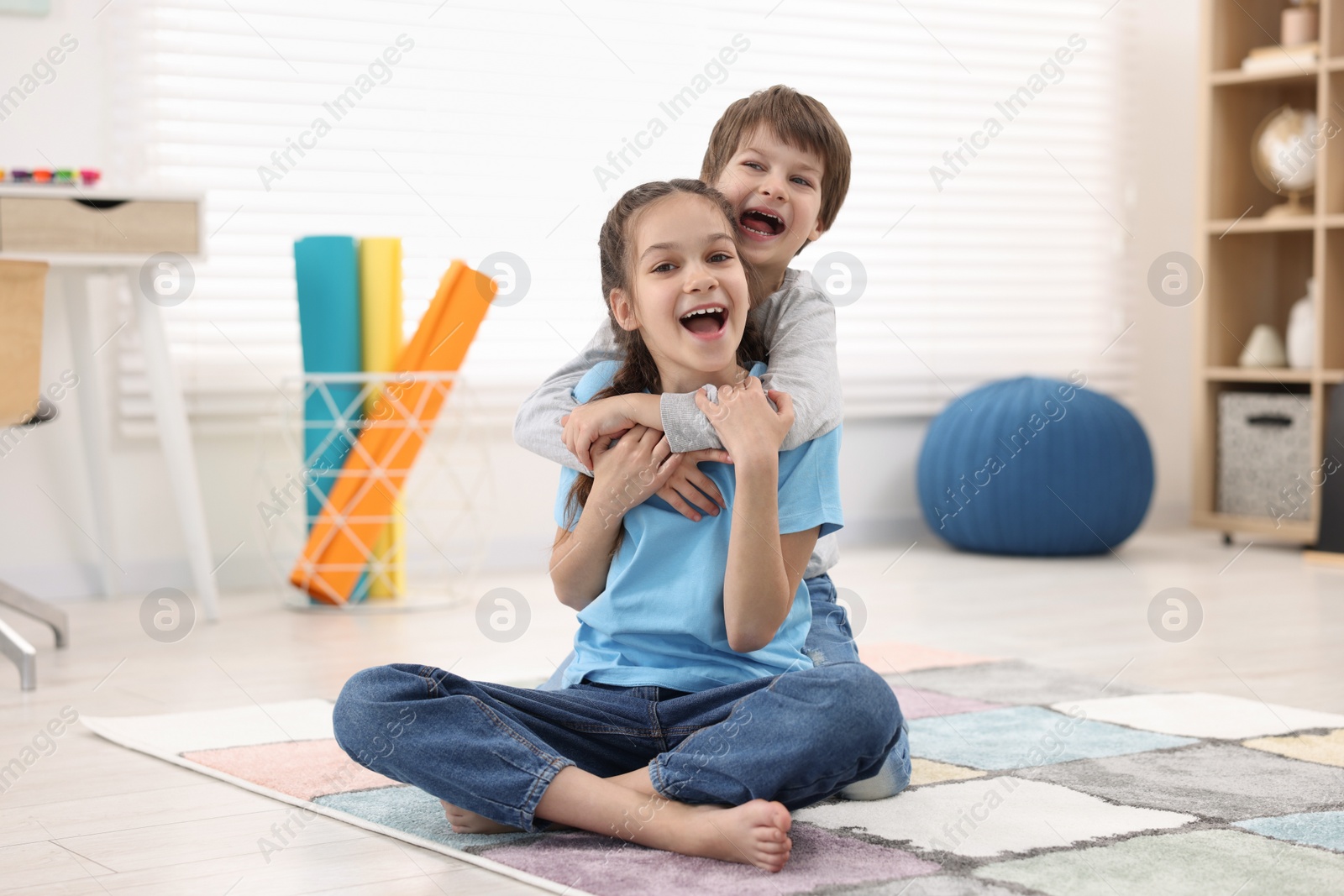 Photo of Happy brother and sister spending time together at home