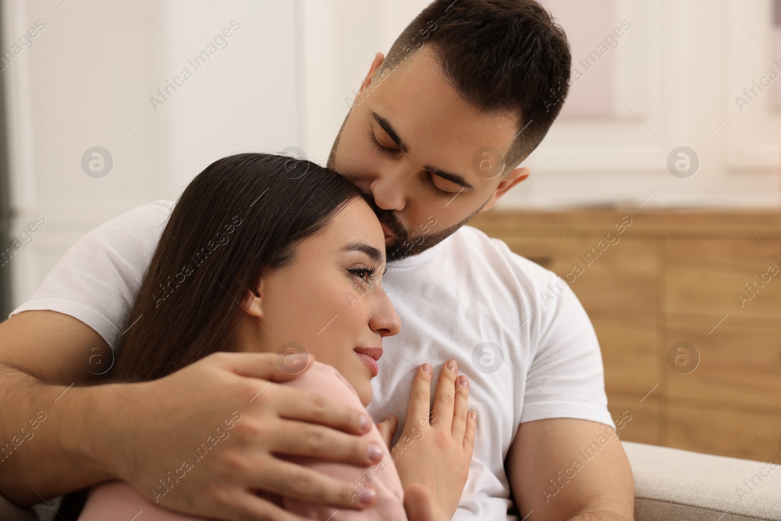 Photo of Affectionate young couple spending time together indoors