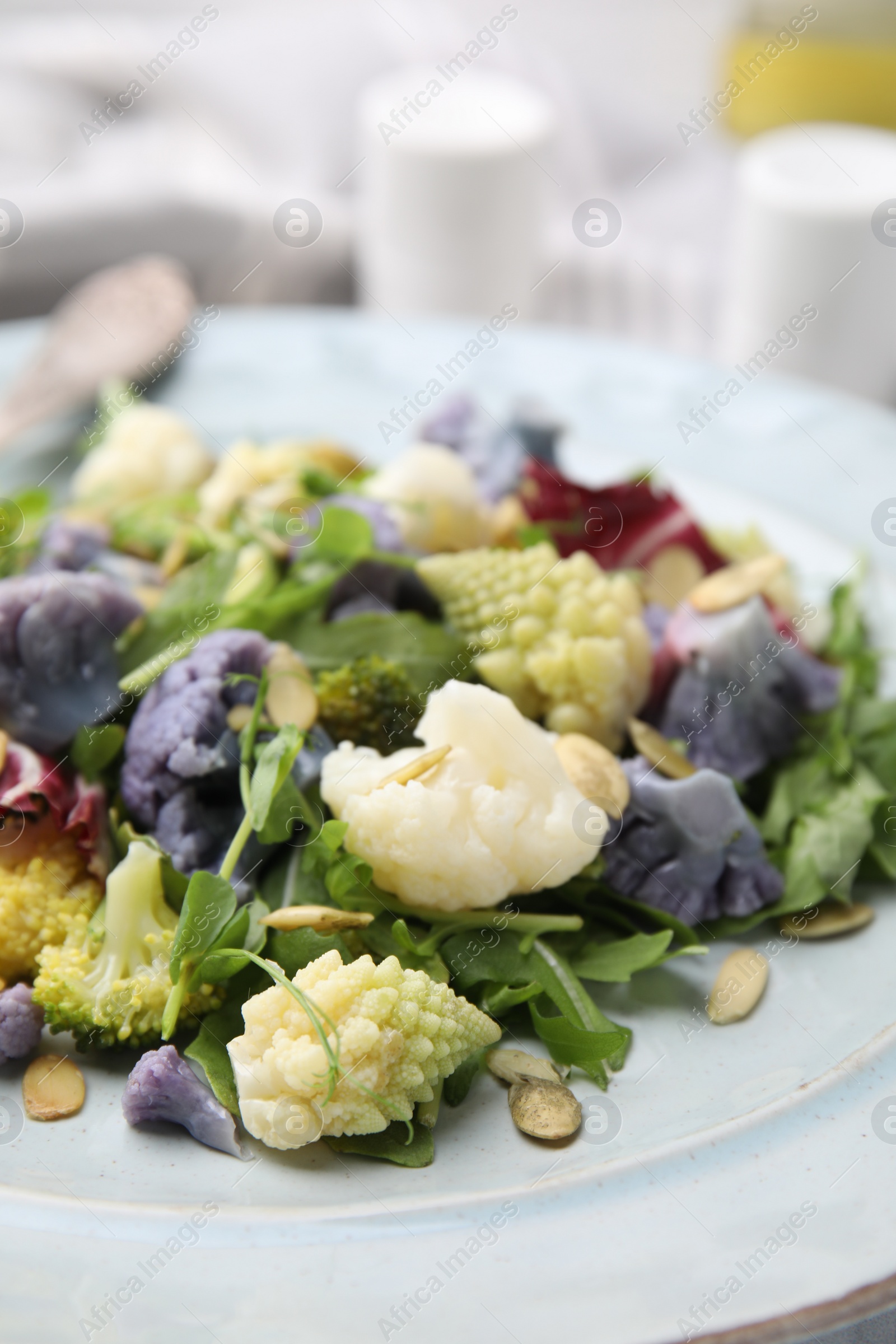 Photo of Delicious salad with cauliflower and pumpkin seeds in plate, closeup