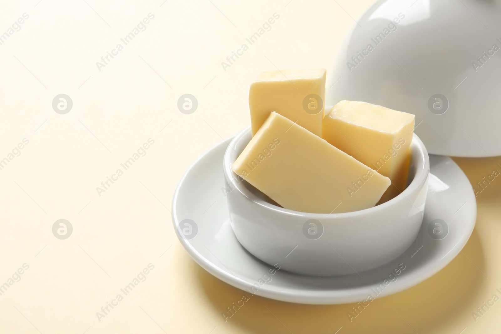 Photo of Dish with fresh butter on color background. Space for text