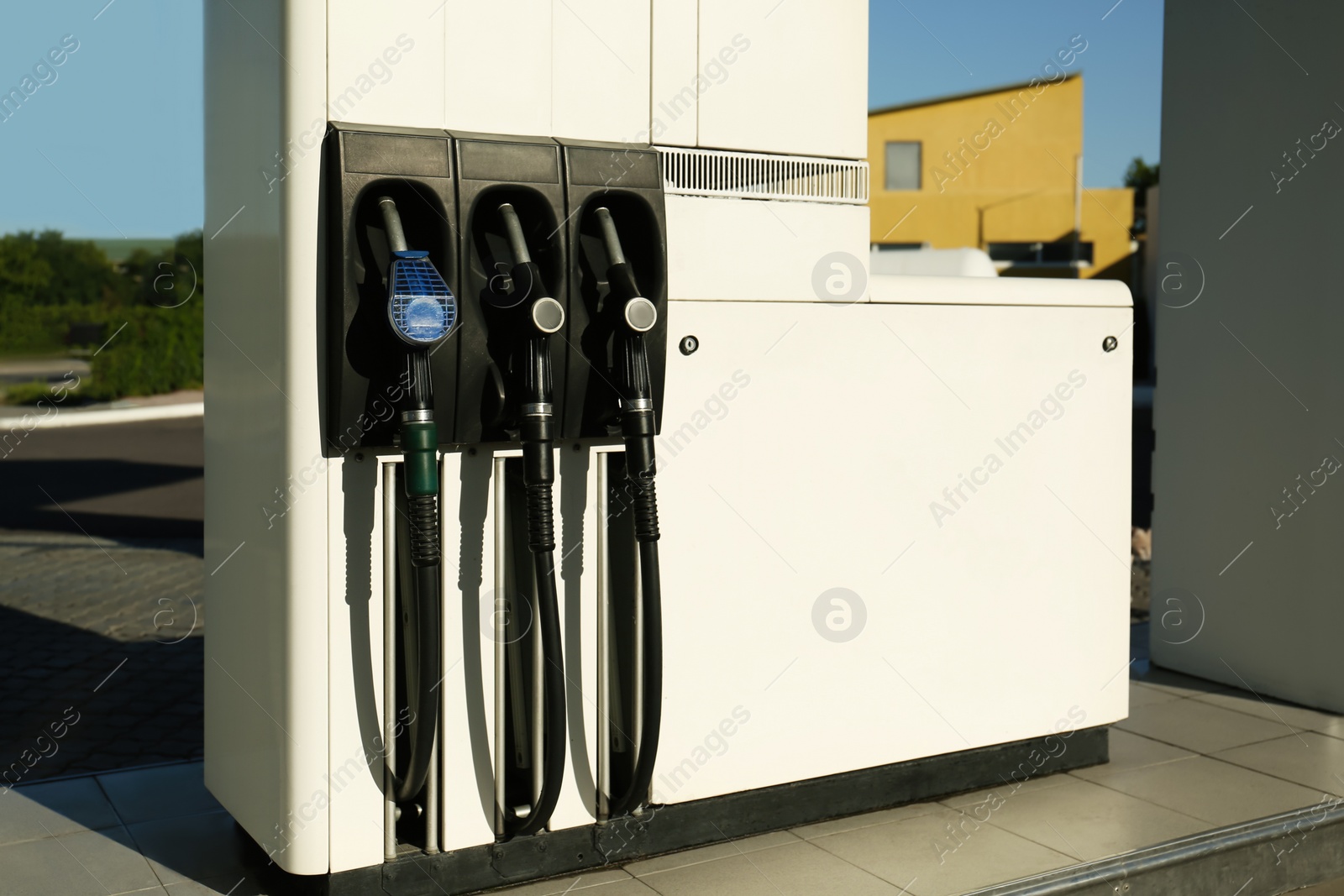 Photo of Petrol pump filling nozzles at gas station