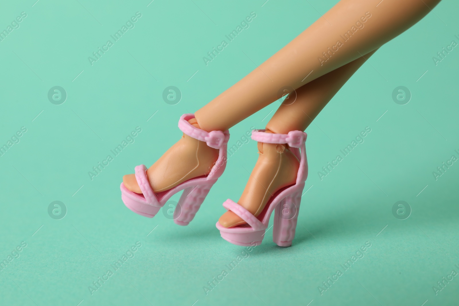 Photo of Mykolaiv, Ukraine - September 2, 2023: Barbie doll wearing beautiful heels on turquoise background, closeup