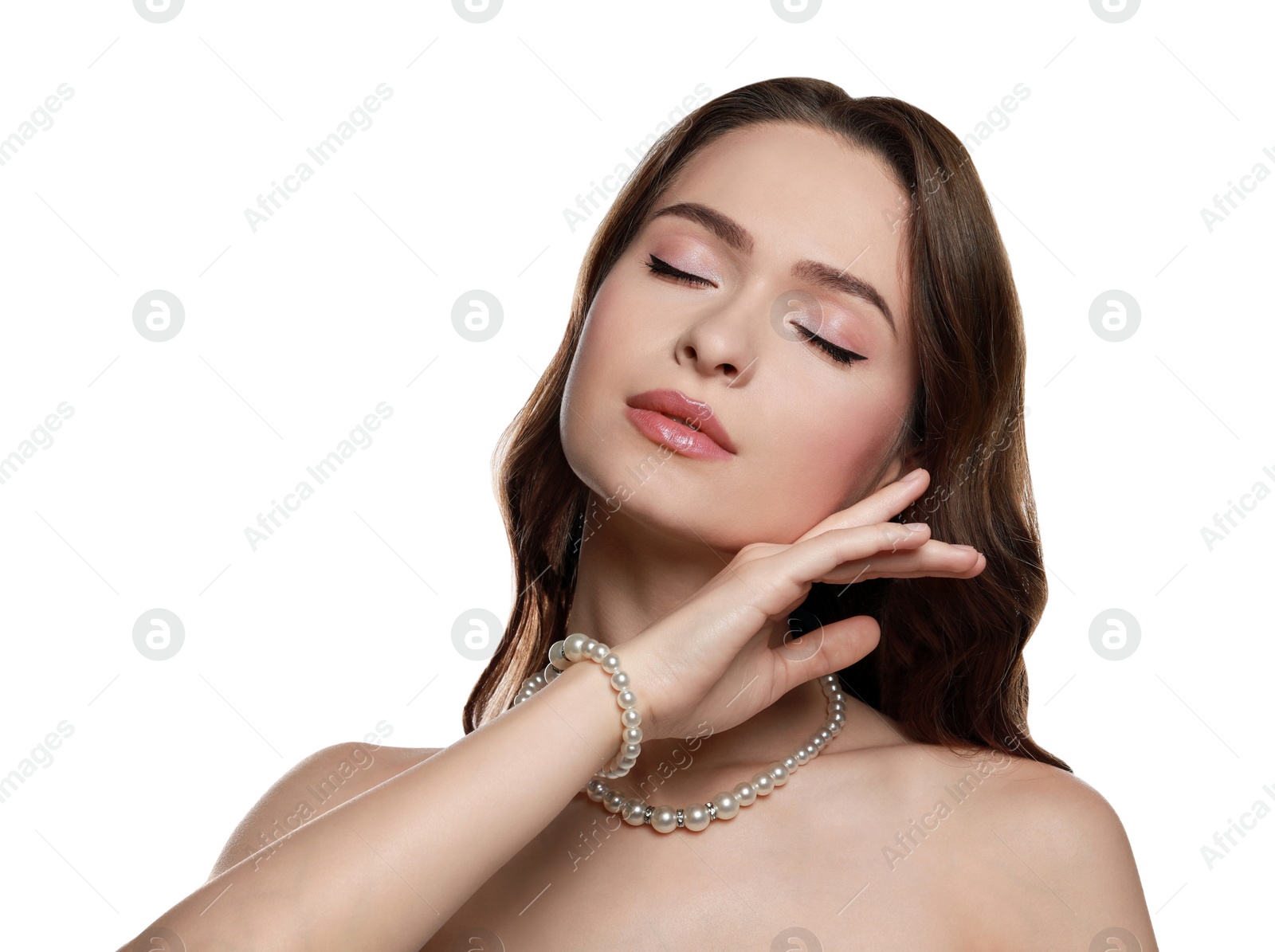 Photo of Young woman wearing elegant pearl jewelry on white background