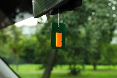 Photo of Air freshener hanging in car against windshield