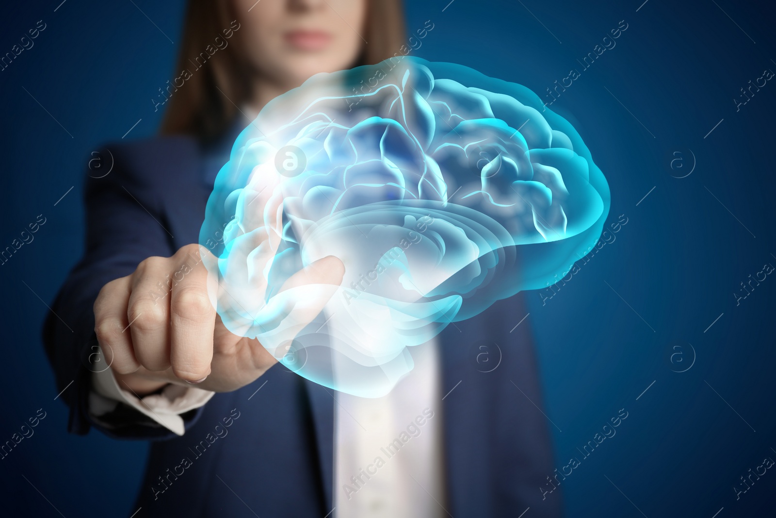 Image of Young woman pointing at digital image of brain on blue background, closeup