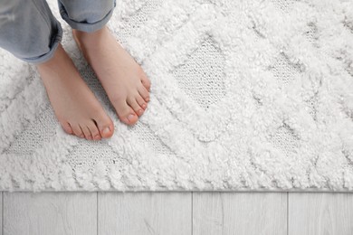 Photo of Woman standing on beige carpet, top view. Space for text