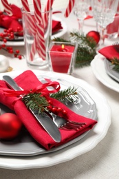 Photo of Festive table setting with beautiful dishware and Christmas decor on white background