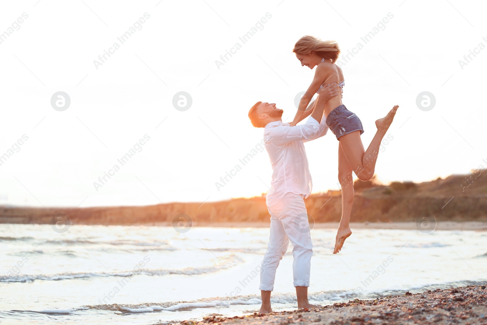 Photo of Young couple spending time together on beach