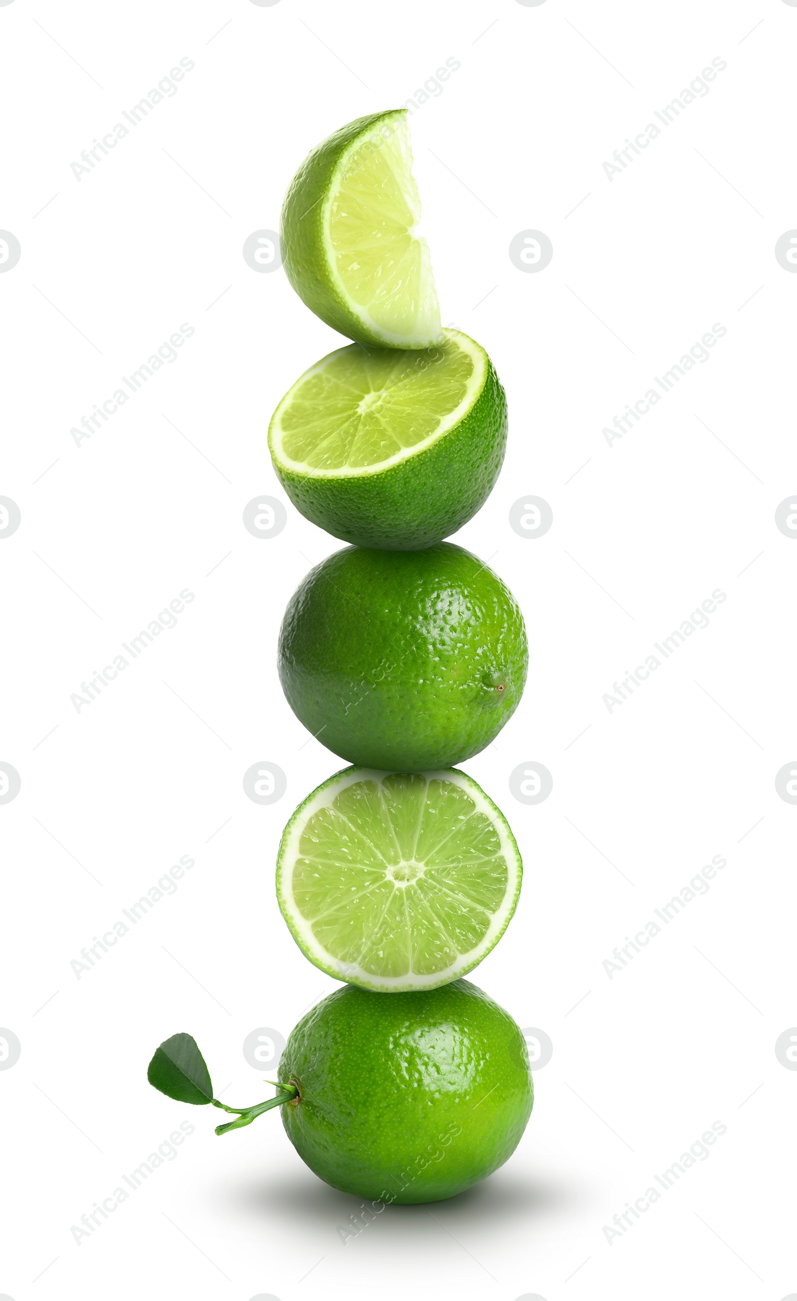 Image of Many stacked whole and cut limes on white background