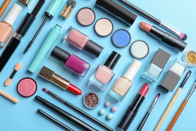 Flat lay composition with decorative cosmetics on color background