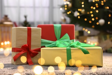 Photo of Many beautiful Christmas gifts on carpet indoors