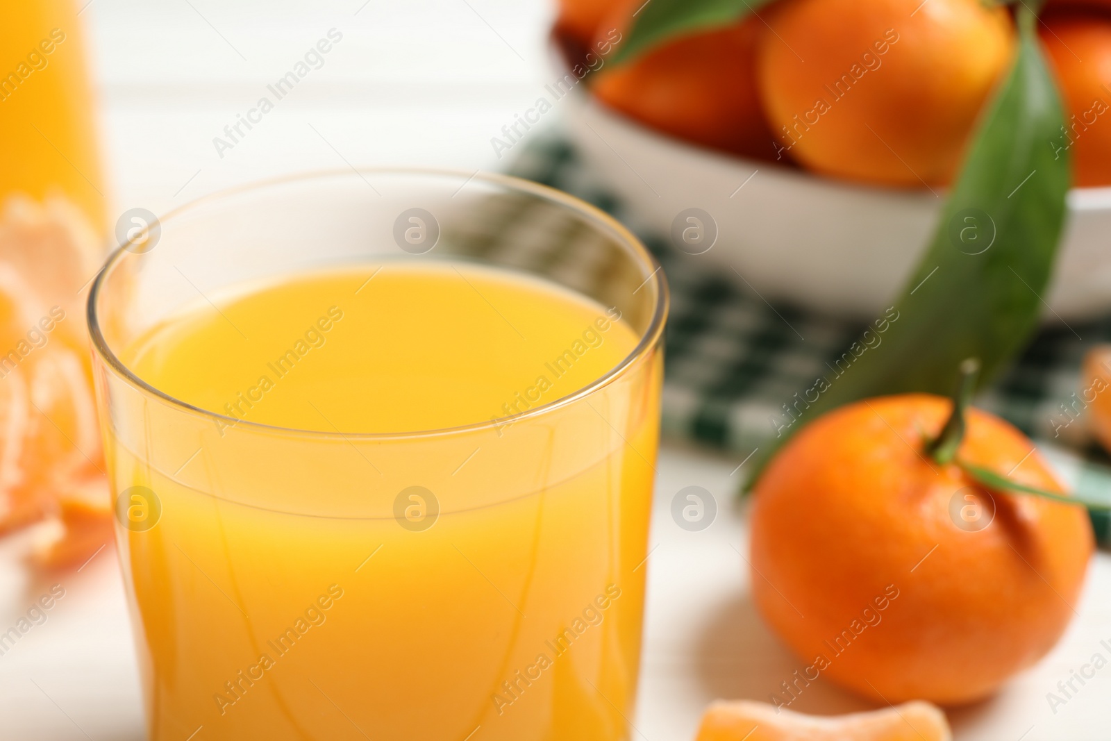 Photo of Glass of fresh tangerine juice, closeup view