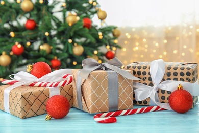 Photo of Beautiful Christmas composition with festive decor and gift boxes on table