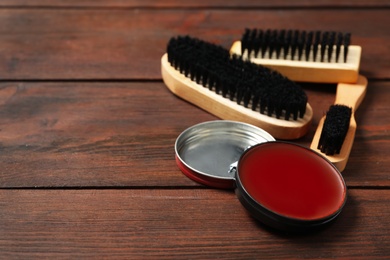 Composition with shoe care accessories on wooden background, closeup. Space for text