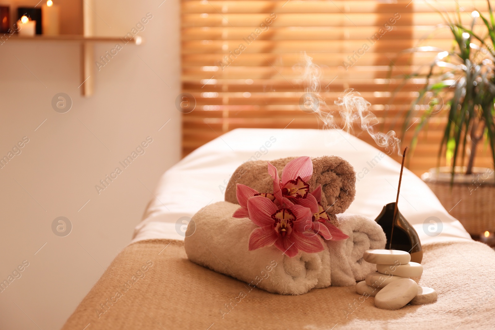 Photo of Beautiful spa accessories in massage room, space for text