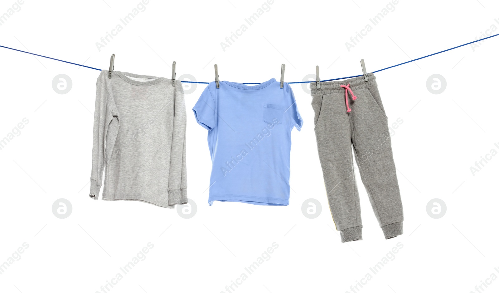 Photo of Different clothes drying on washing line against white background