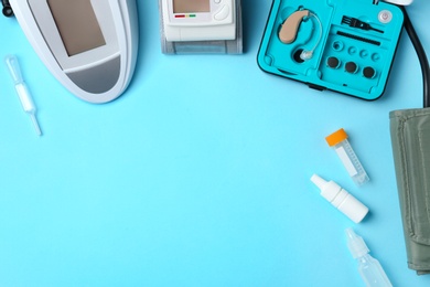 Photo of Flat lay composition with different medical objects and space for text on color background