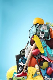 Photo of Many different sports equipment on light blue background