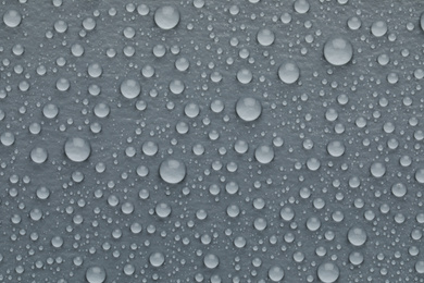 Photo of Water drops on grey background, top view