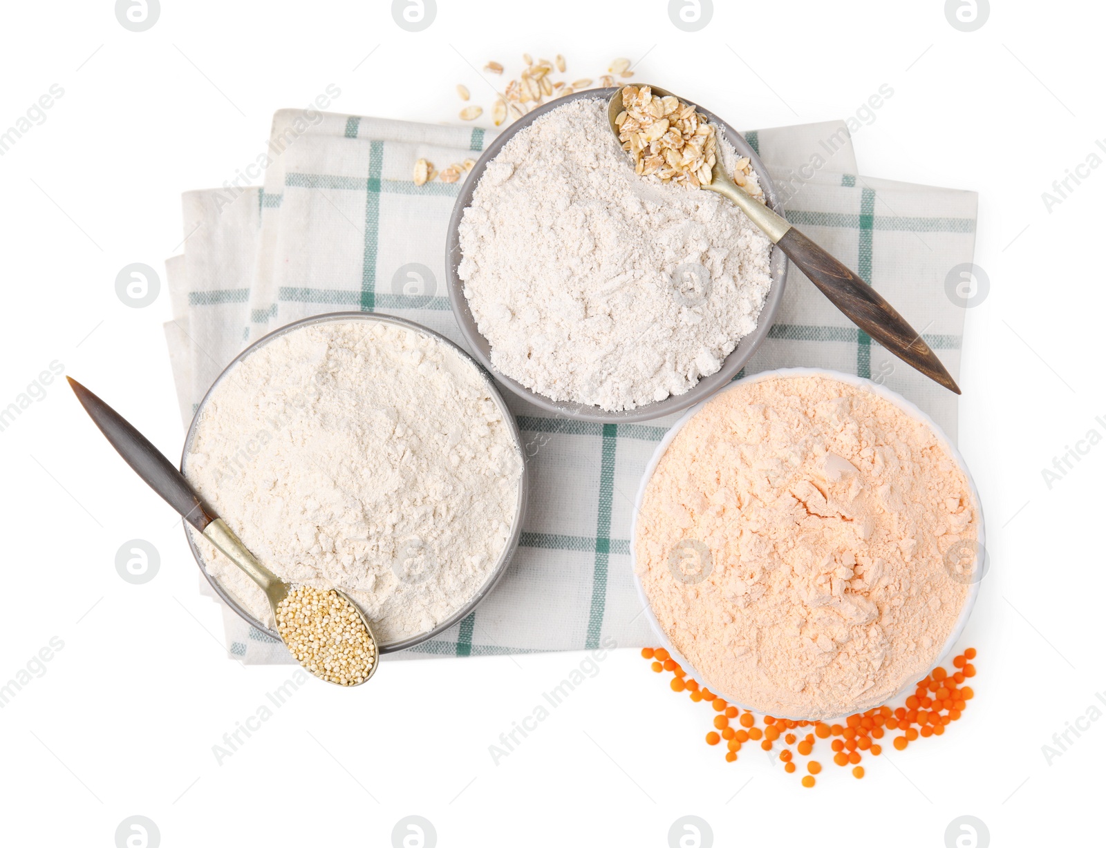 Photo of Different types of flour and tablecloth on white background, top view