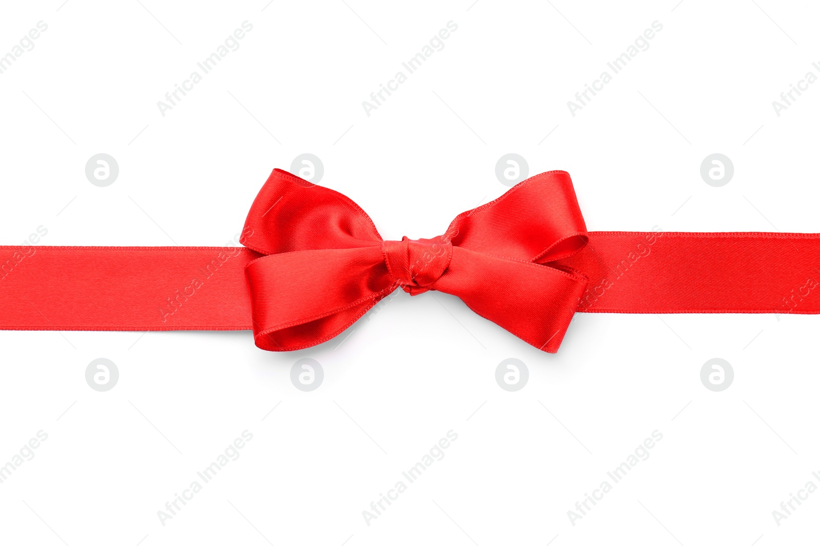 Photo of Red ribbon with bow on white background, top view