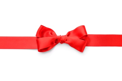 Red ribbon with bow on white background, top view