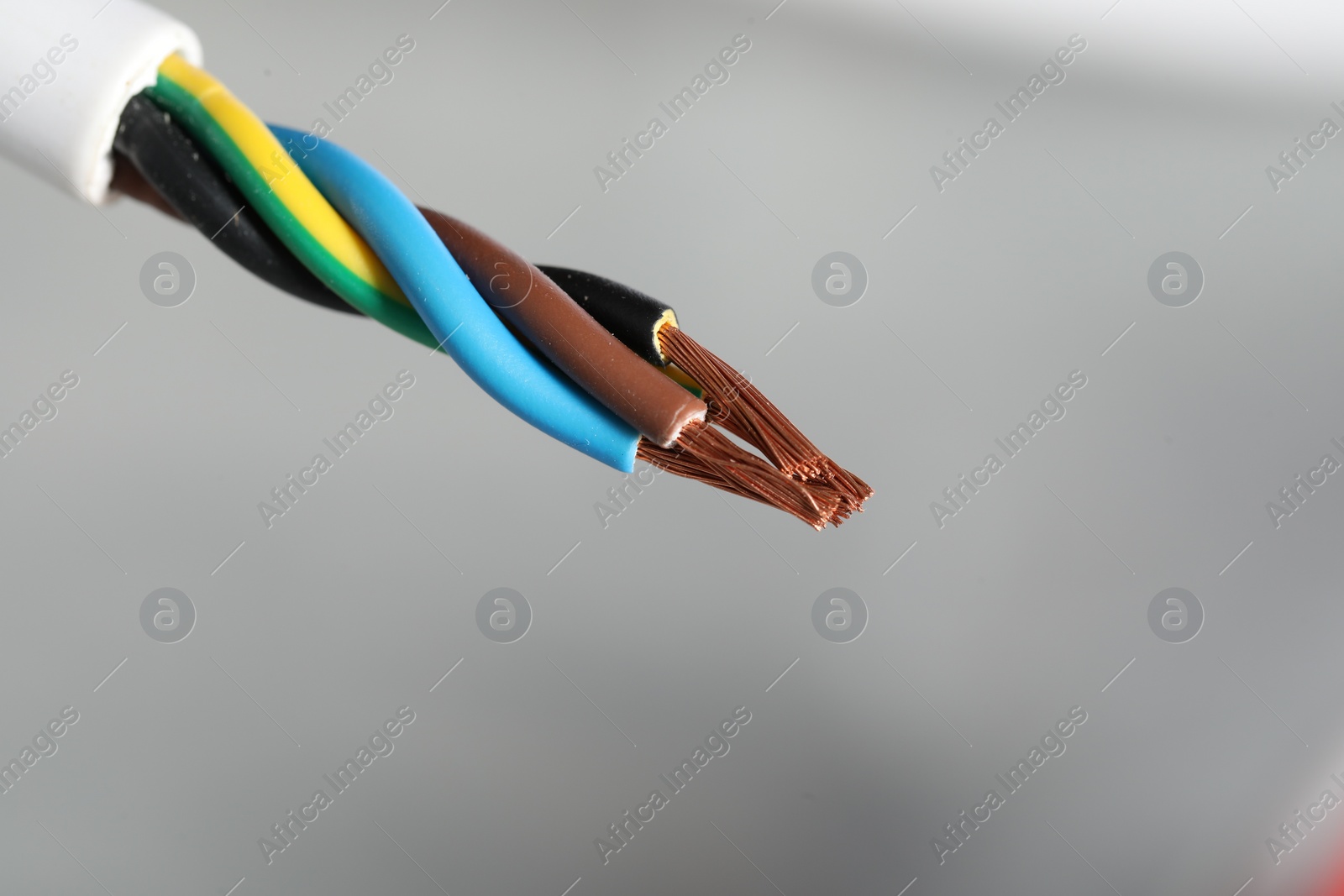 Photo of Colorful electrical wire on gray background, closeup. Space for text