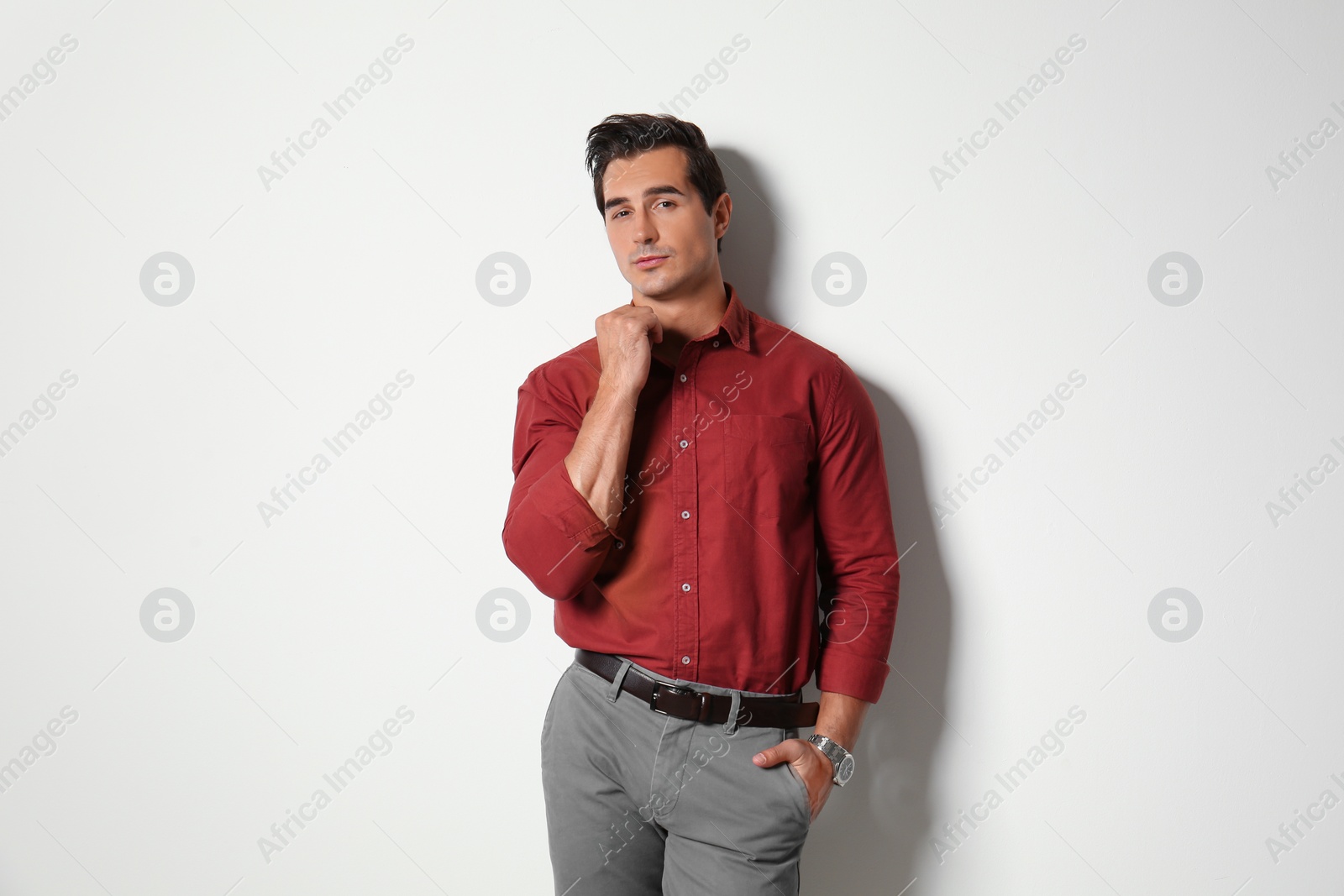 Photo of Handsome young man in stylish clothes on light beige background