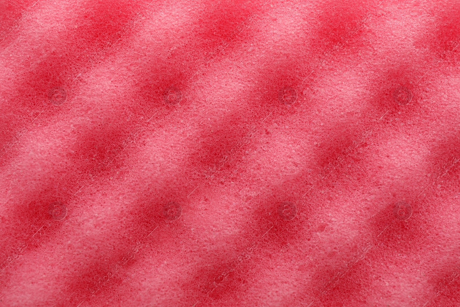 Photo of Pink cleaning sponge as background, top view