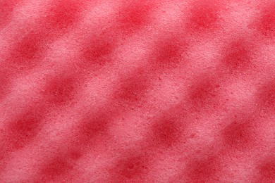 Pink cleaning sponge as background, top view