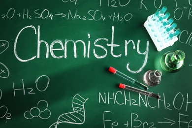 Photo of Flat lay composition with laboratory glassware on chalkboard. Chemistry concept