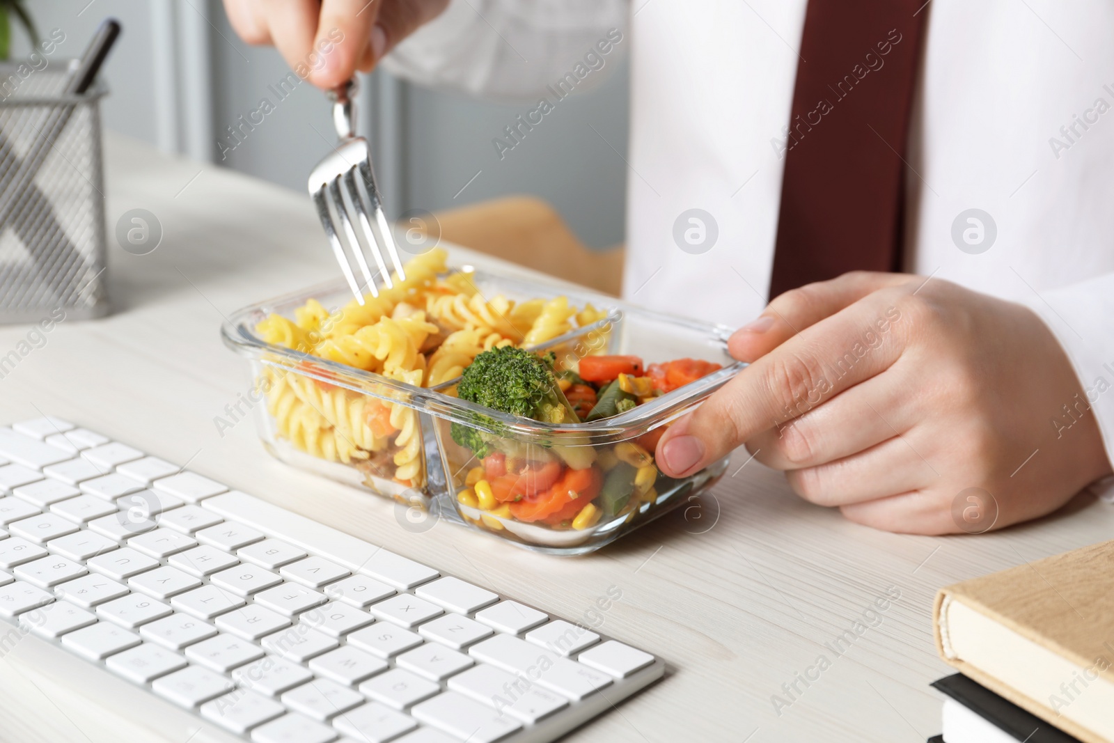 Photo of Office employee having business lunch at workplace, closeup