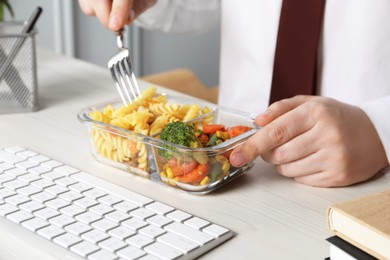 Office employee having business lunch at workplace, closeup