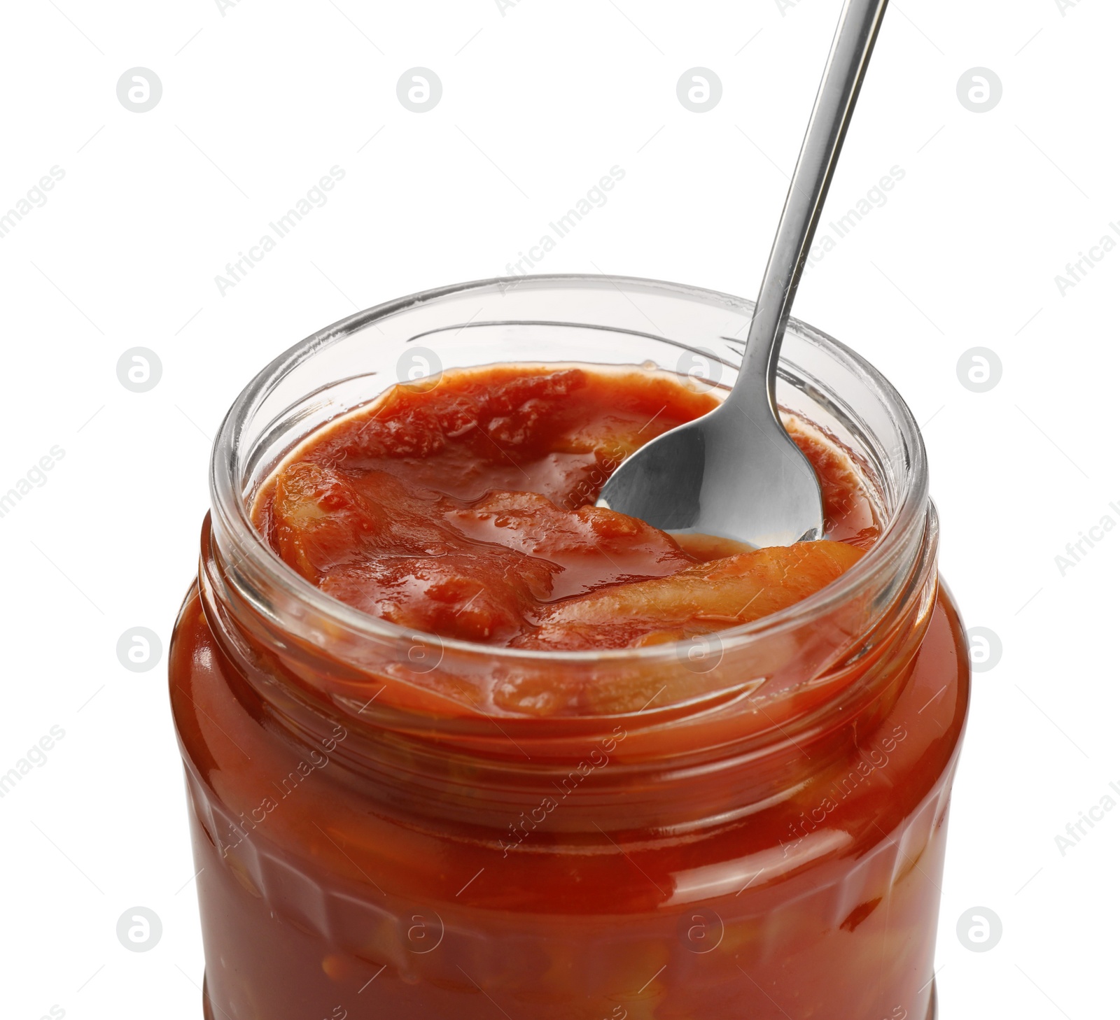 Photo of Glass jar of delicious canned lecho with spoon isolated on white, closeup