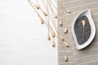 Flat lay composition with poppy seeds on wooden background