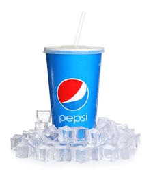 Photo of MYKOLAIV, UKRAINE - JUNE 9, 2021: Paper Pepsi cup with water drops and ice cubes isolated on white