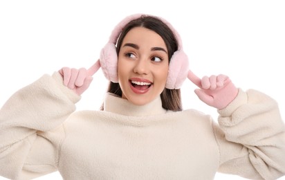 Photo of Beautiful young woman wearing earmuffs on white background