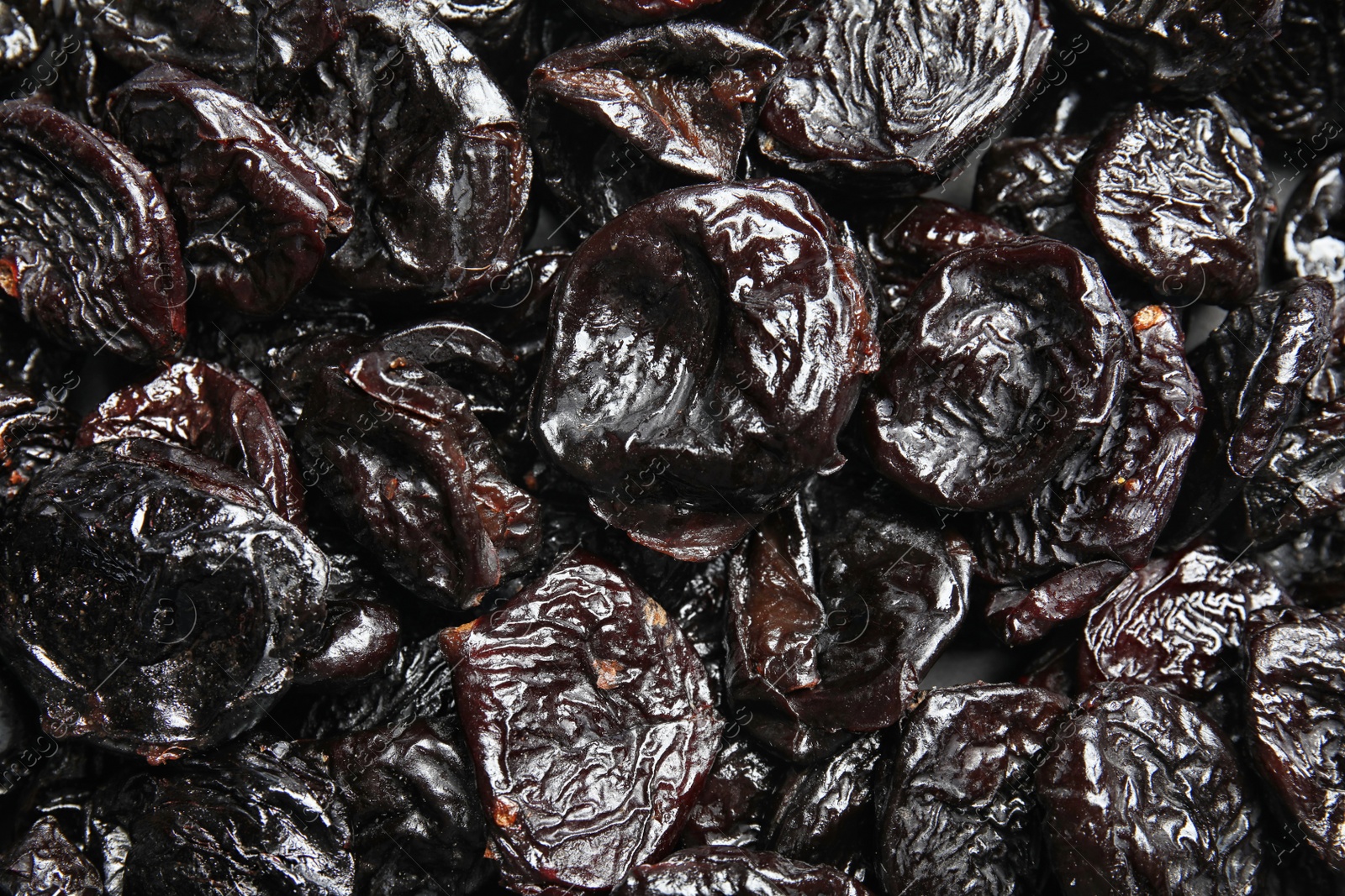 Photo of Tasty prunes as background, top view. Dried fruit as healthy snack