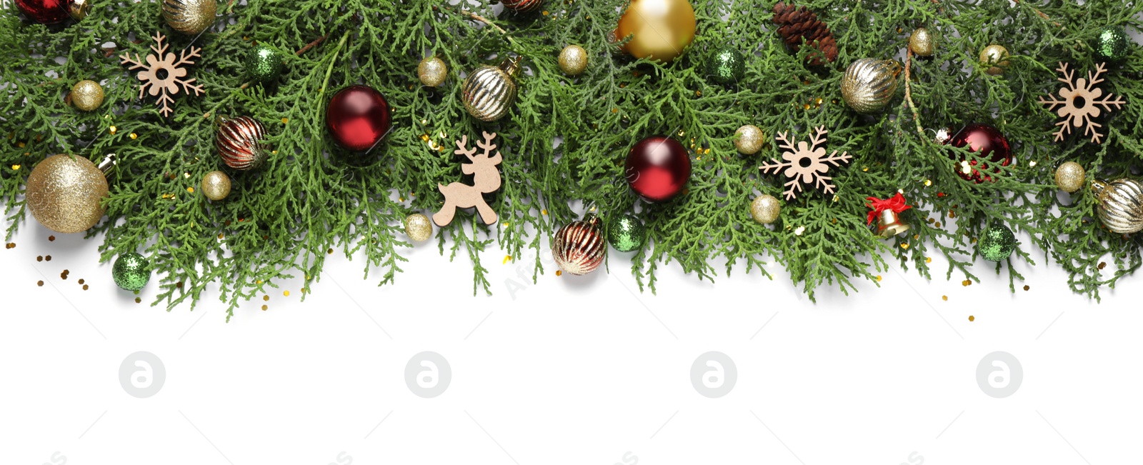 Photo of Thuja branches with Christmas decorations on white background, flat lay