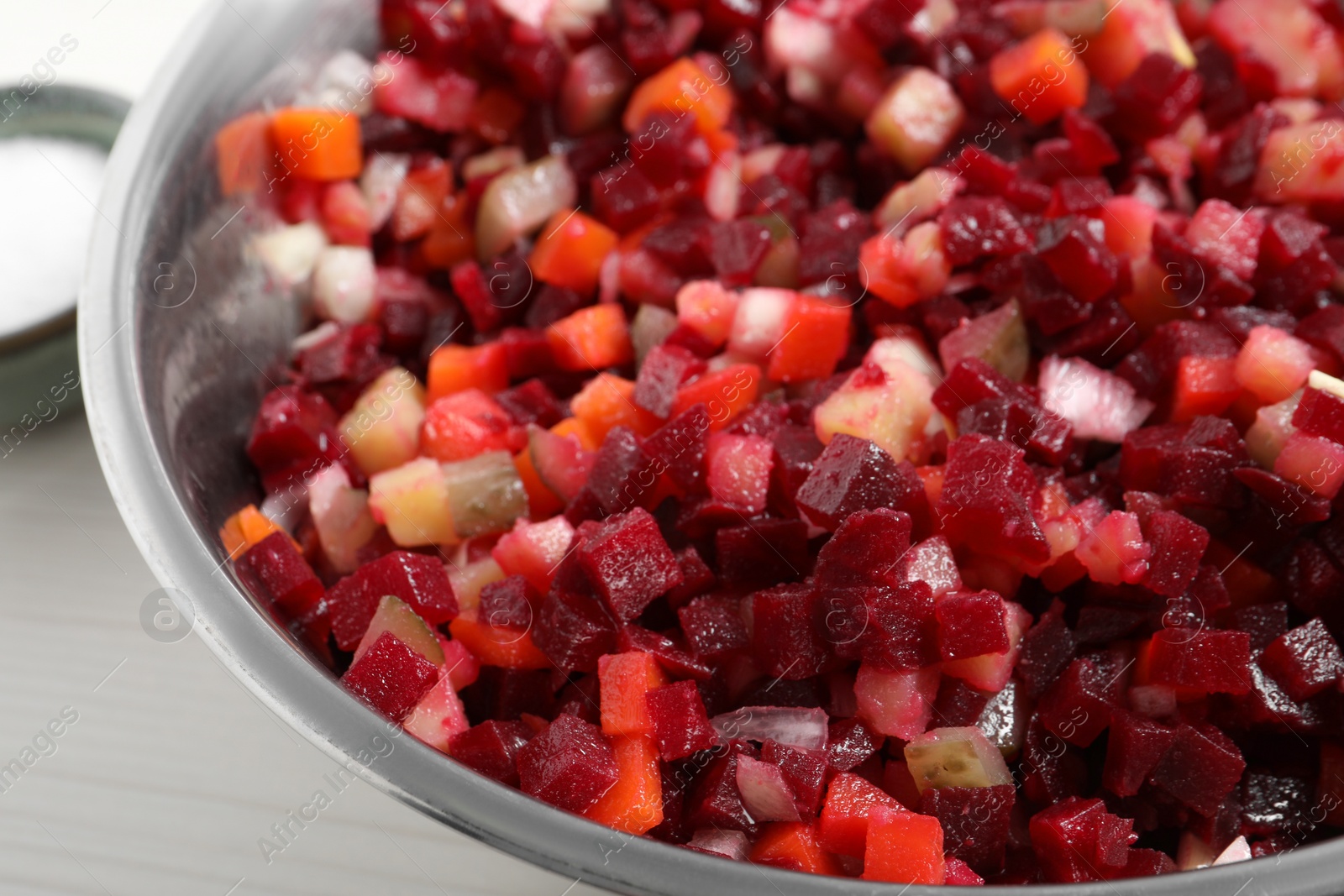 Photo of Delicious fresh vinaigrette salad on table, closeup