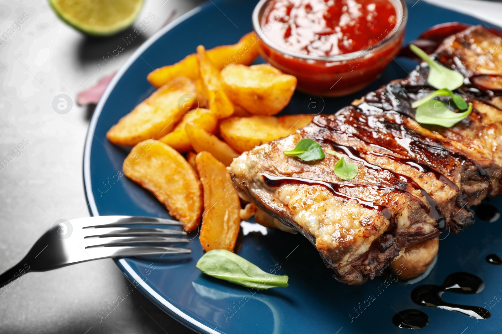 Photo of Delicious grilled ribs served on table, closeup