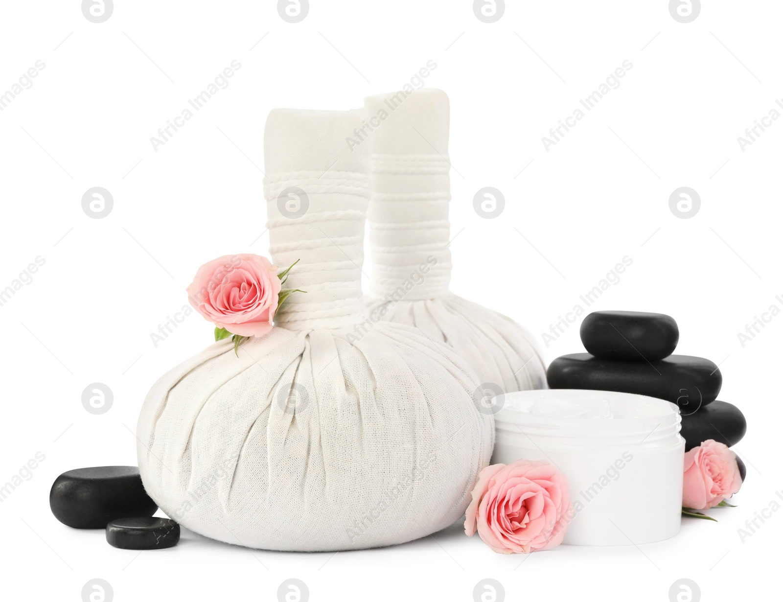 Photo of Herbal massage bags, spa stones, flowers and cream on white background