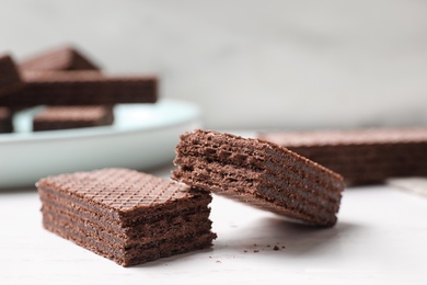 Delicious chocolate wafers on white table, closeup