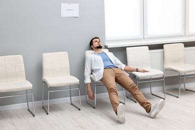 Photo of Tired man waiting for job interview indoors