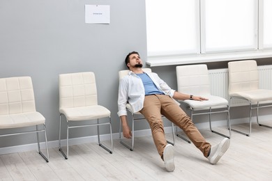 Tired man waiting for job interview indoors