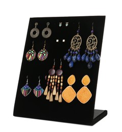 Photo of Display stand with different earrings on white background